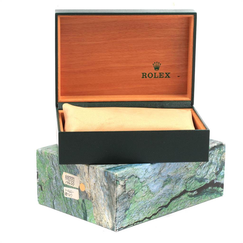 The image shows a Rolex Submariner 16613 Men's Steel and Gold (two tone) Black Dial 16613 Men's Steel and Gold (two tone) Black Dial model watch box, with the lid open to reveal a plush cushion inside.