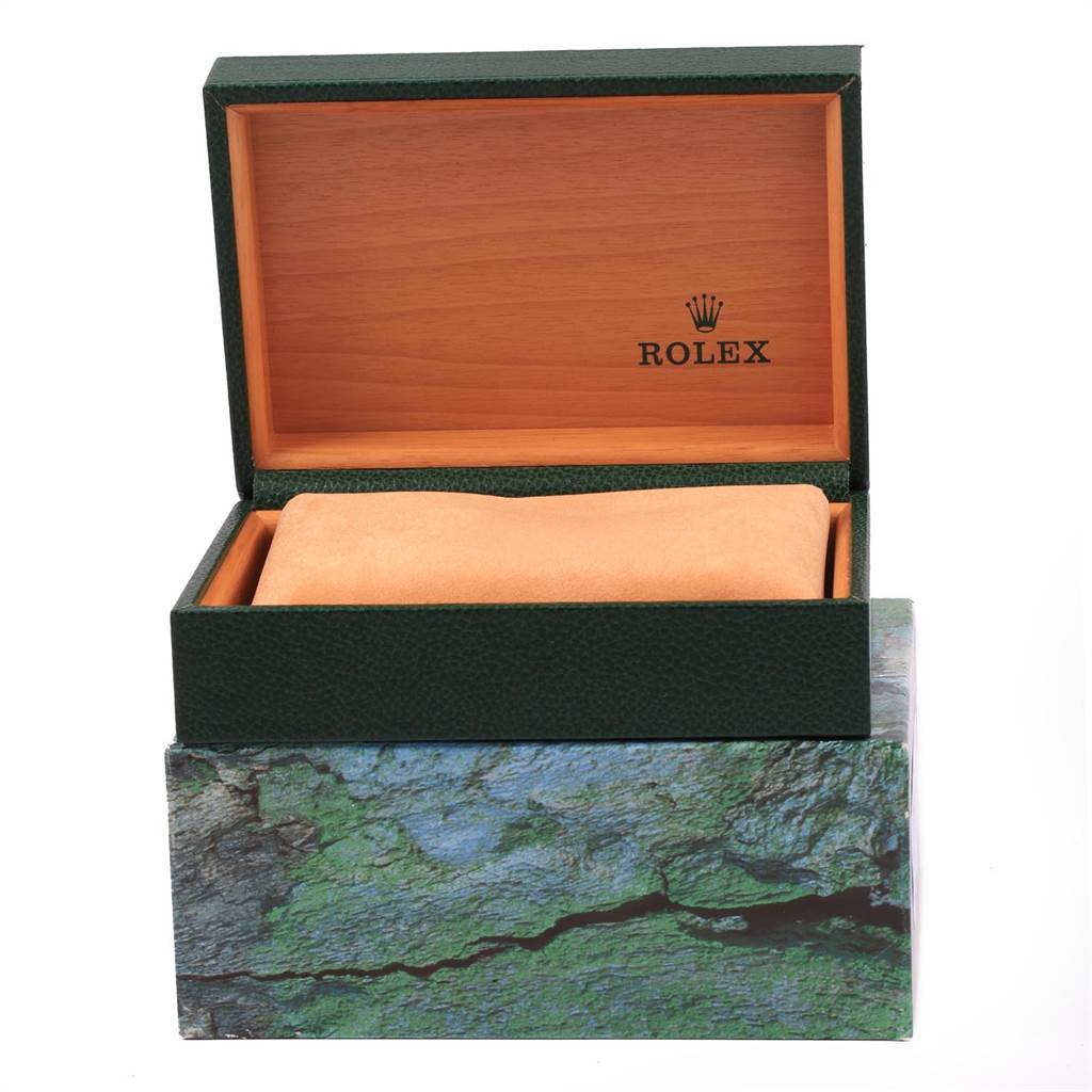 The image shows an open Rolex Submariner 16613 Men's Steel and Gold (two tone) Blue Dial 16613 Men's Steel and Gold (two tone) Blue Dial watch box from a front angle, revealing its interior cushion and branded wooden lining.