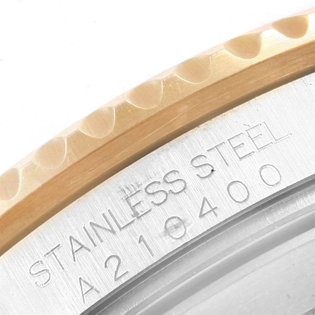 This image shows a close-up of the bezel and engraved case back of a Rolex Submariner 16613 Men's Steel and Gold (two tone) Blue Dial 16613 Men's Steel and Gold (two tone) Blue Dial watch.