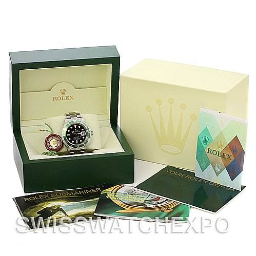 The image shows a Rolex Submariner 16610V Men's Stainless Steel Black Dial 16610V Men's Stainless Steel Black Dial watch, displayed in its original green box, alongside its outer packaging and various accessories.