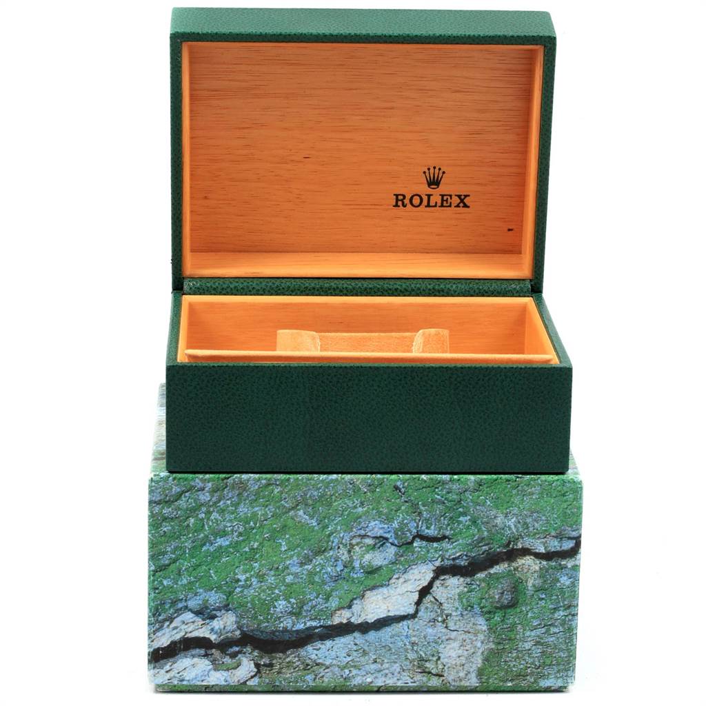 The image shows an open Rolex watch box for the Submariner model, with a green exterior and wood interior.