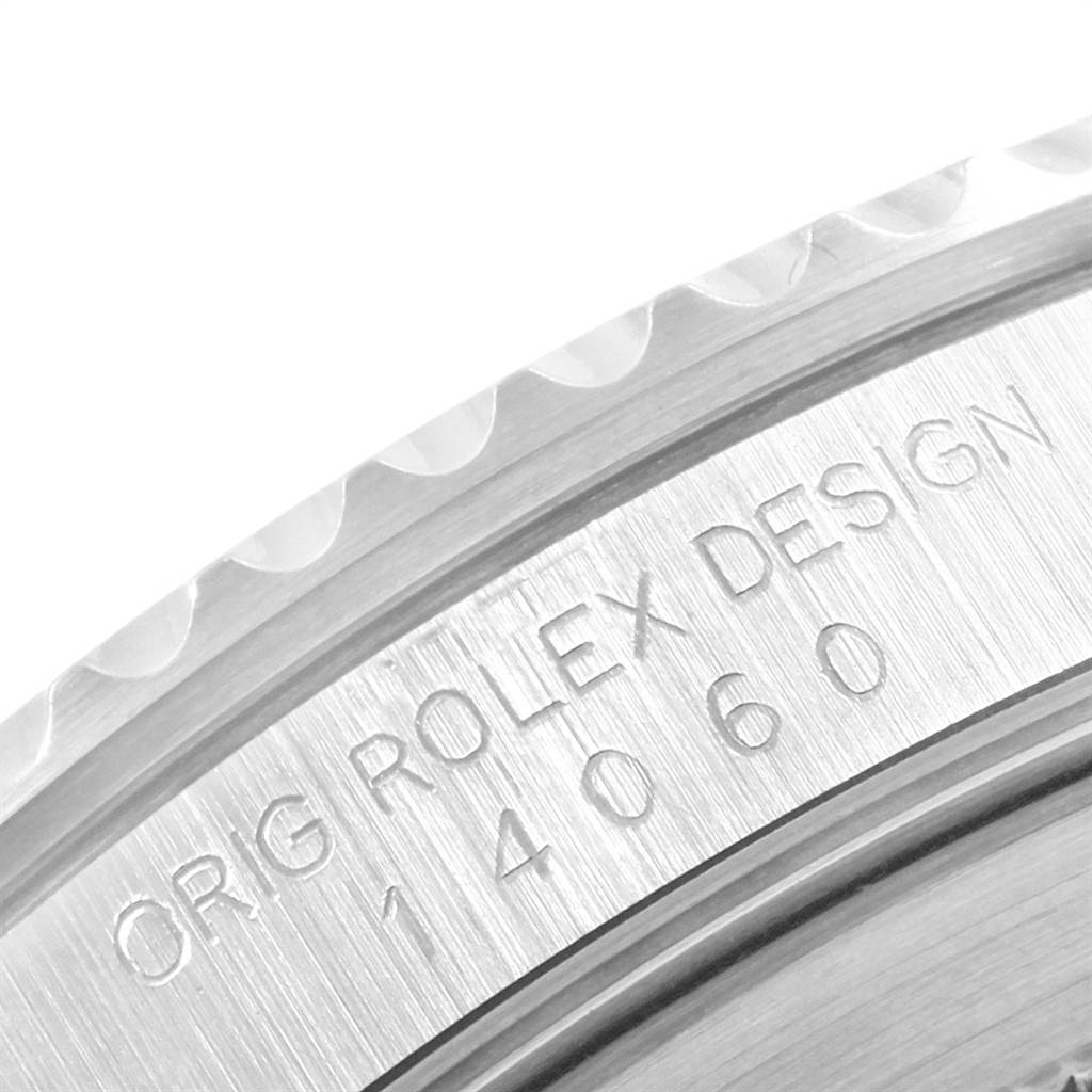 This image shows a close-up of the engraved serial number and design details on the case back edge of a Rolex Submariner 14060 Men's Stainless Steel Black Dial 14060 Men's Stainless Steel Black Dial model.