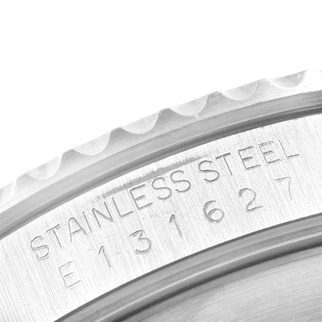 This close-up image shows the engraved serial number and "Stainless Steel" text on the case of a Rolex Submariner 14060 Men's Stainless Steel Black Dial 14060 Men's Stainless Steel Black Dial watch.