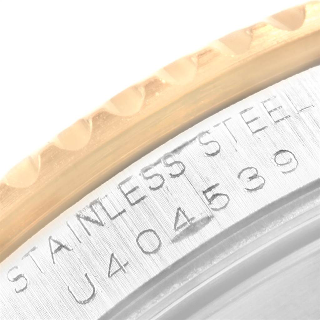 This image shows a close-up of the Rolex Submariner 16613 Men's Steel and Gold (two tone) Blue Dial 16613 Men's Steel and Gold (two tone) Blue Dial model, highlighting the engraved serial number and stainless steel parts.