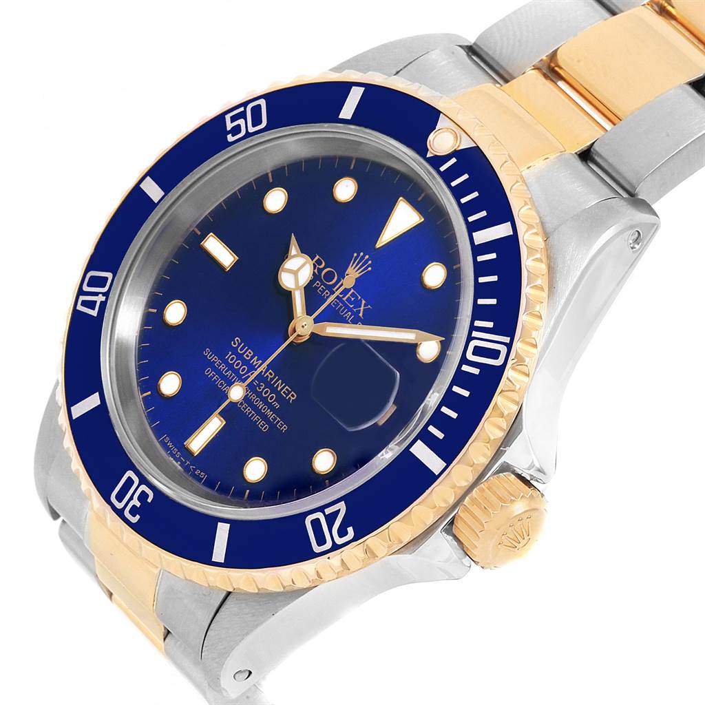 The Rolex Submariner 16613 Men's Steel and Gold (two tone) Blue Dial 16613 Men's Steel and Gold (two tone) Blue Dial watch is shown at an angled close-up featuring its blue dial, bezel, crown, and part of the two-tone bracelet.