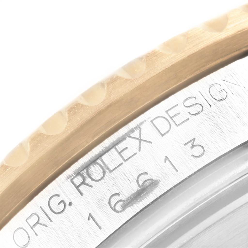 This image shows a close-up of the bezel and engraved casing of a Rolex Submariner 16613 Men's Steel and Gold (two tone) Blue Dial 16613 Men's Steel and Gold (two tone) Blue Dial watch, displaying part of the model number.