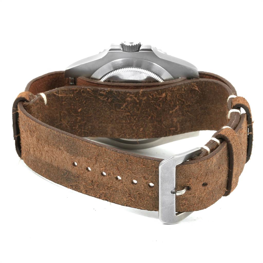 The image shows the back of a Rolex Submariner 114060 Men's Stainless Steel Black Dial 114060 Men's Stainless Steel Black Dial watch with a brown leather strap and metallic buckle.