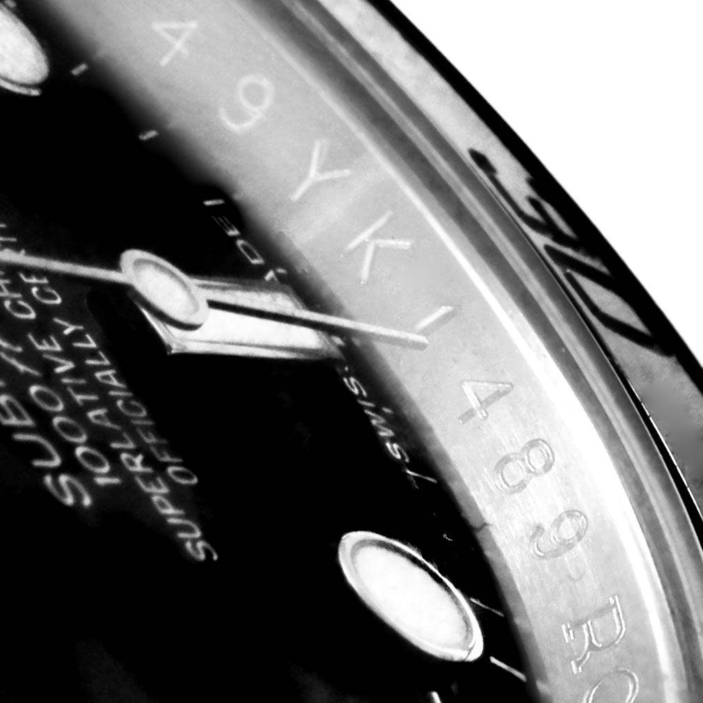 The image shows a close-up of the dial and part of the bezel of a Rolex Submariner 114060 Men's Stainless Steel Black Dial 114060 Men's Stainless Steel Black Dial watch, focusing on the markers and hands.