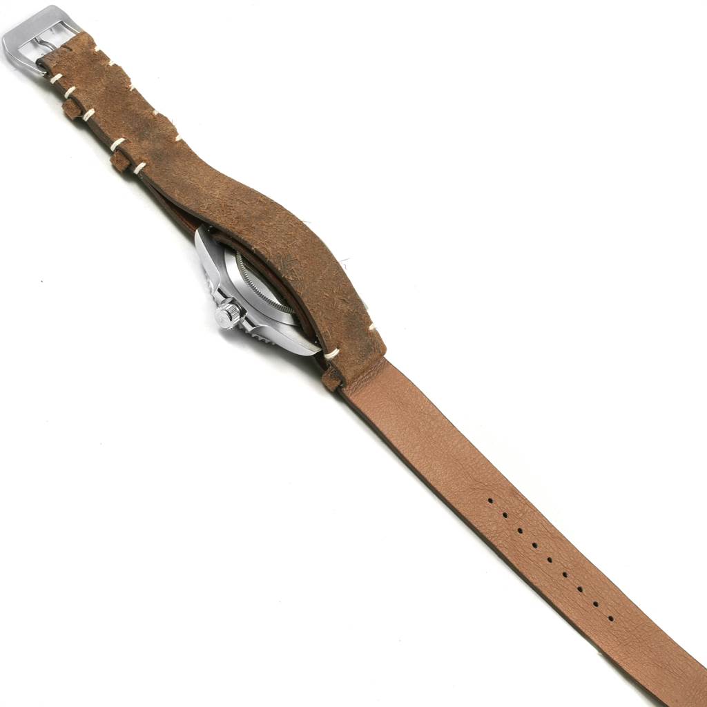 The image shows the side view of a Rolex Submariner 114060 Men's Stainless Steel Black Dial 114060 Men's Stainless Steel Black Dial watch with a brown leather strap fully extended.