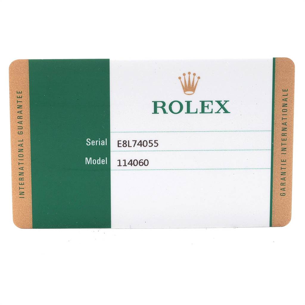 The image shows a Rolex International Guarantee card detailing the serial and model numbers for a Rolex Submariner 114060 Men's Stainless Steel Black Dial 114060 Men's Stainless Steel Black Dial, model 114060.