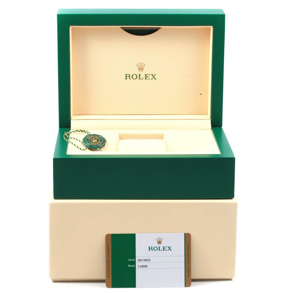 The image shows the open box for a Rolex Submariner 114060 Men's Stainless Steel Black Dial 114060 Men's Stainless Steel Black Dial watch, along with the warranty card and a tag.