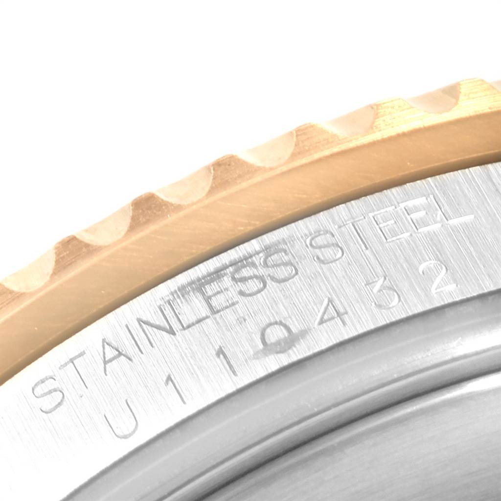 This image shows a close-up of the bezel and serial number engraving on a Rolex Submariner 16613 Men's Steel and Gold (two tone) Black Dial 16613 Men's Steel and Gold (two tone) Black Dial watch.