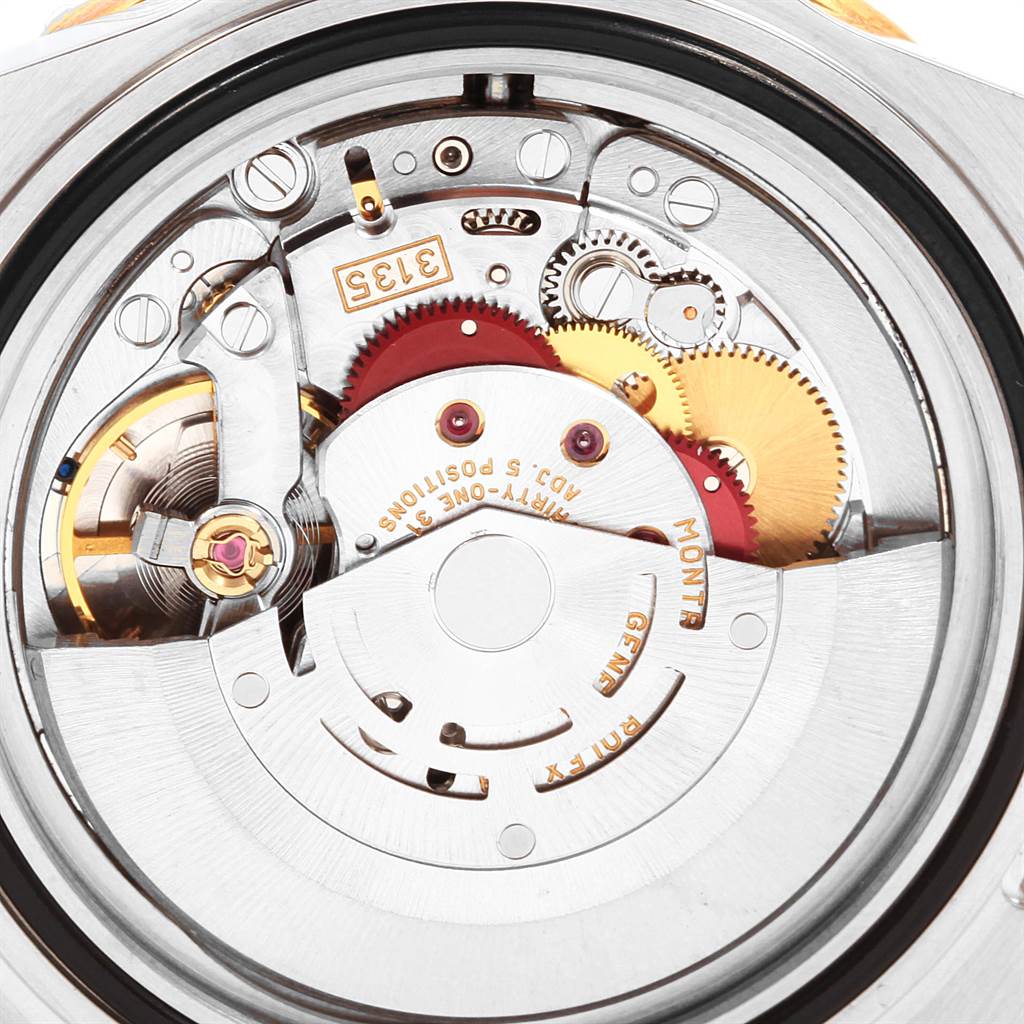 This image shows the open case back of a Rolex Submariner 16613 Men's Steel and Gold (two tone) Blue Dial 16613 Men's Steel and Gold (two tone) Blue Dial, revealing its intricate movement parts and mechanisms.