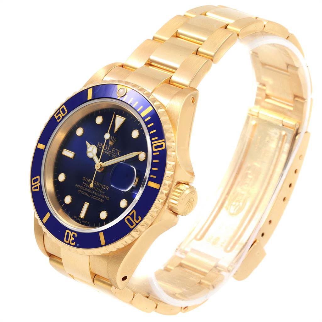 The image shows a Rolex Submariner 16618 Men's Yellow Gold Blue Dial 16618 Men's Yellow Gold Blue Dial watch at an angled view, highlighting the gold bracelet, blue bezel, and dial.