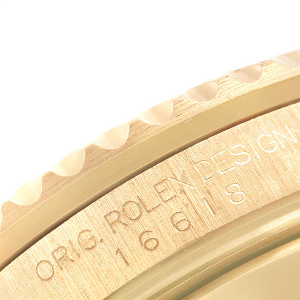 The image shows a close-up of the side engraving and the bezel of a Rolex Submariner 16618 Men's Yellow Gold Blue Dial 16618 Men's Yellow Gold Blue Dial 16618.