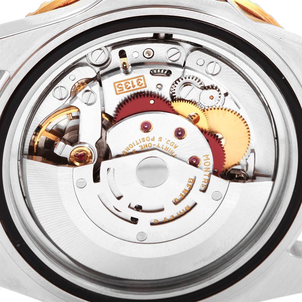 This image shows a close-up of the movement and inner mechanics of a Rolex Submariner 16613 Men's Steel and Gold (two tone) Blue Dial 16613 Men's Steel and Gold (two tone) Blue Dial watch.