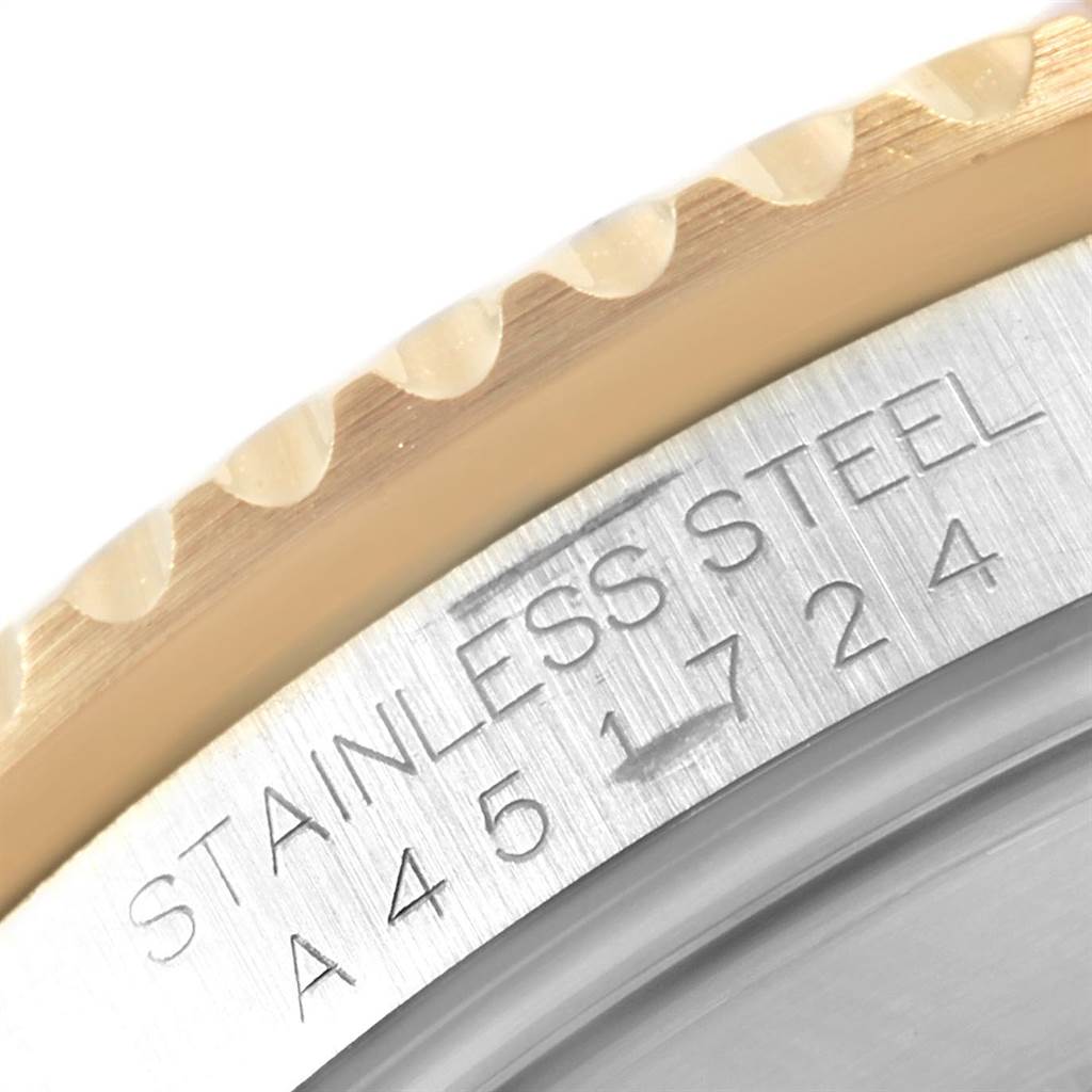 This image shows a close-up of the case and bezel of a Rolex Submariner 16613 Men's Steel and Gold (two tone) Blue Dial 16613 Men's Steel and Gold (two tone) Blue Dial, highlighting the "Stainless Steel" engraving.