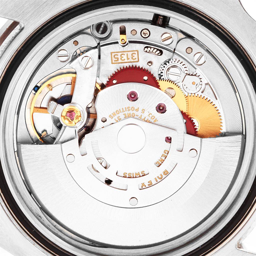 The image shows a close-up view of the movement mechanism of a Rolex Submariner 116610LV Men's Stainless Steel Green Dial 116610LV Men's Stainless Steel Green Dial watch, highlighting gears and components.