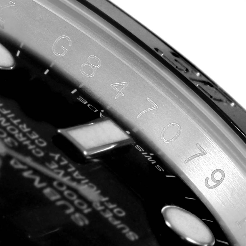 This close-up image of a Rolex Submariner 116610 Men's Stainless Steel Black Dial 116610 Men's Stainless Steel Black Dial showcases the serial number engraved on its inner bezel.