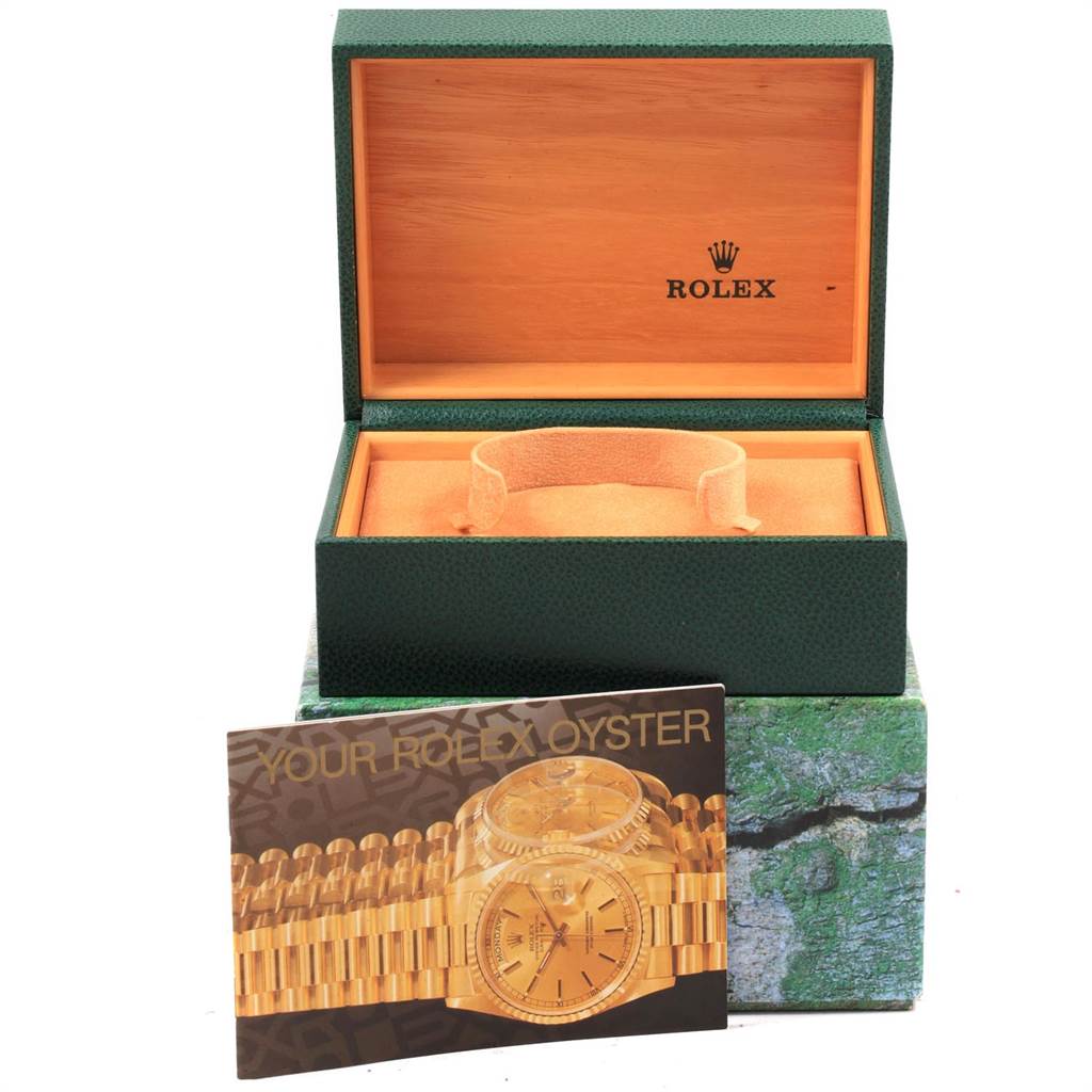 The image shows an empty Rolex Submariner 16613 Men's Steel and Gold (two tone) Champagne Dial 16613 Men's Steel and Gold (two tone) Champagne Dial watch box and a booklet with information about the watch.