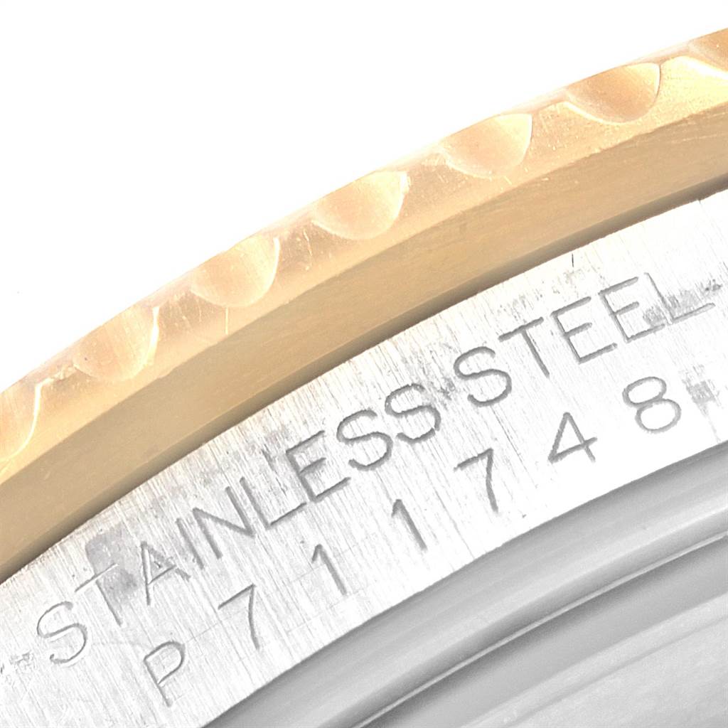 This close-up image shows the engraved stainless steel part of the Rolex Submariner 16613 Men's Steel and Gold (two tone) Champagne Dial 16613 Men's Steel and Gold (two tone) Champagne Dial watch case and part of the bezel.
