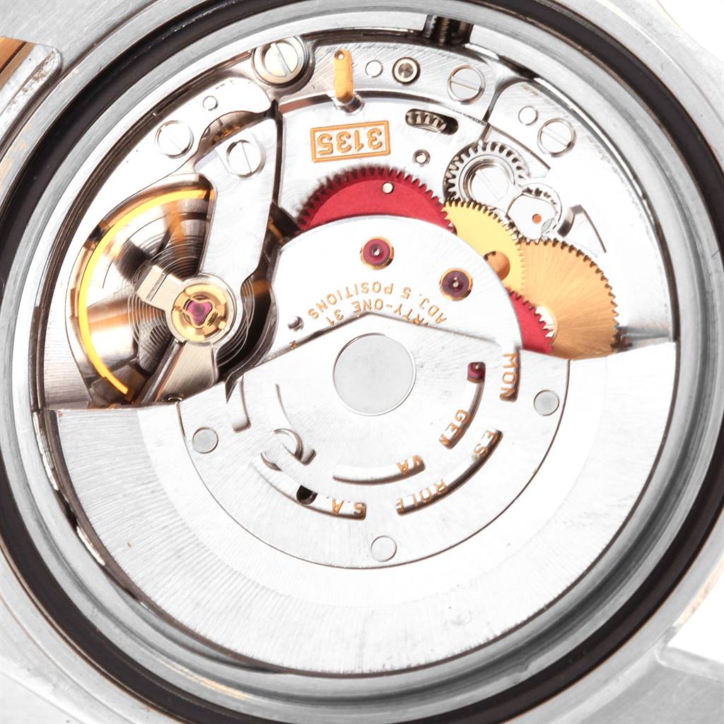 This is a close-up of the internal mechanical movement of a Rolex Submariner 16613 Men's Steel and Gold (two tone) Champagne Dial 16613 Men's Steel and Gold (two tone) Champagne Dial watch, showing gears and other components.