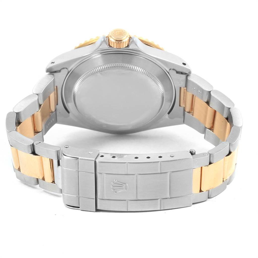 The image shows the back view of a Rolex Submariner 16613 Men's Steel and Gold (two tone) Blue Dial 16613 Men's Steel and Gold (two tone) Blue Dial watch, highlighting the case back and dual-tone bracelet with the clasp open.