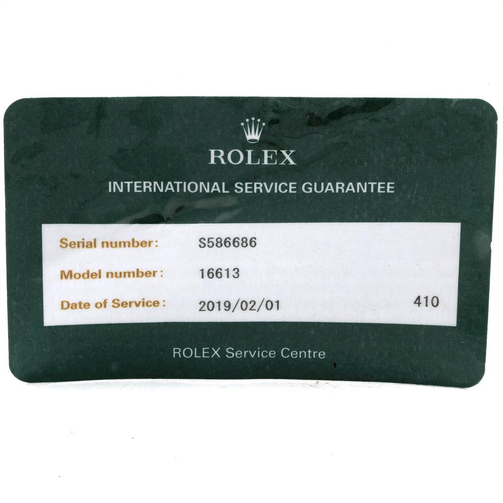 This image displays a Rolex Submariner 16613 Men's Steel and Gold (two tone) Blue Dial 16613 Men's Steel and Gold (two tone) Blue Dial service guarantee card with serial number, model number, and service date details.