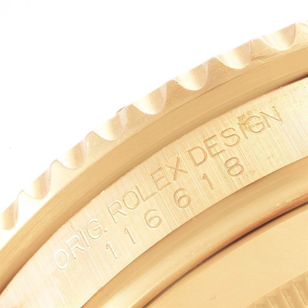 The image shows a close-up angle of the bezel and engraved side of a Rolex Submariner 116618 Men's Yellow Gold Blue Dial 116618 Men's Yellow Gold Blue Dial watch, model number 116618.