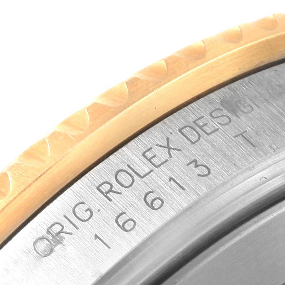 This image shows a close-up of the bezel and engraved case side of the Rolex Submariner 16613 Men's Steel and Gold (two tone) Grey Dial 16613 Men's Steel and Gold (two tone) Grey Dial watch.