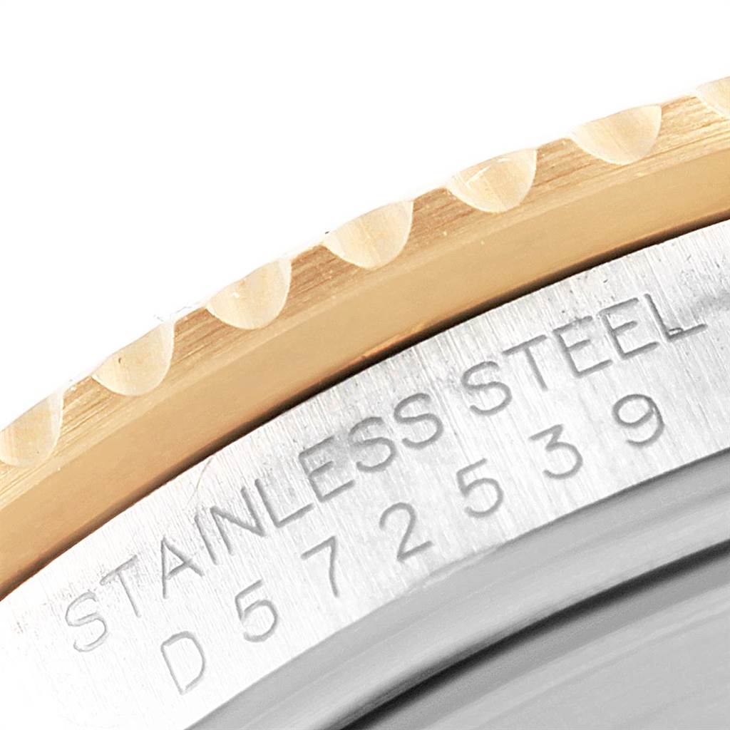 This image shows a close-up of the bezel and engraved serial number of a Rolex Submariner 16613 Men's Steel and Gold (two tone) Grey Dial 16613 Men's Steel and Gold (two tone) Grey Dial watch.