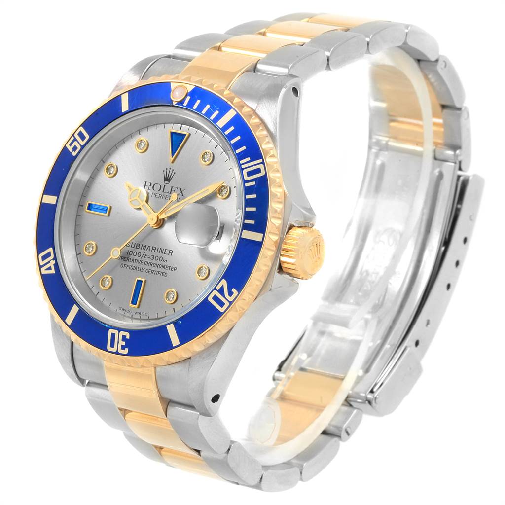 This image shows a Rolex Submariner 16613 Men's Steel and Gold (two tone) Grey Dial 16613 Men's Steel and Gold (two tone) Grey Dial watch at a three-quarter angle, highlighting its dial, bezel, crown, and bracelet.
