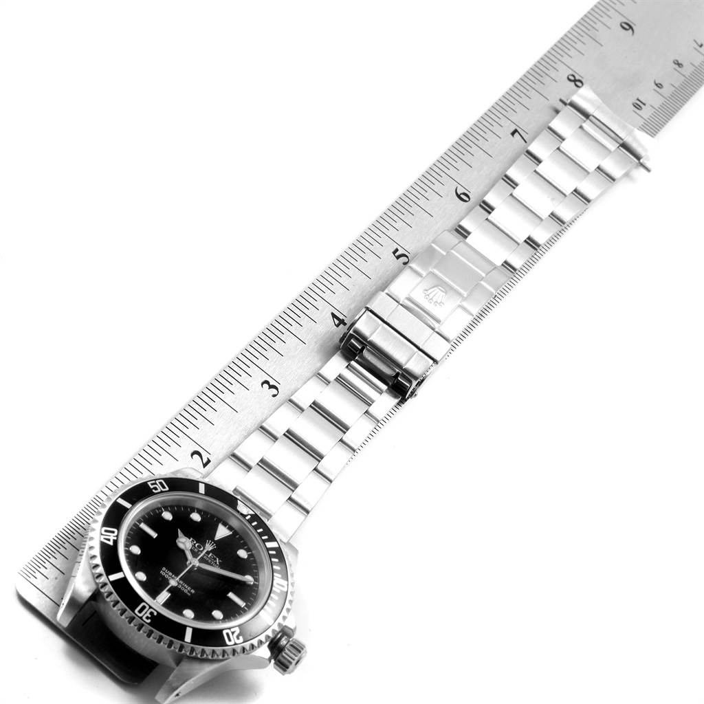 The image shows a Rolex Submariner 14060 Men's Stainless Steel Black Dial 14060 Men's Stainless Steel Black Dial watch laid flat with its bracelet and clasp measured alongside a ruler.