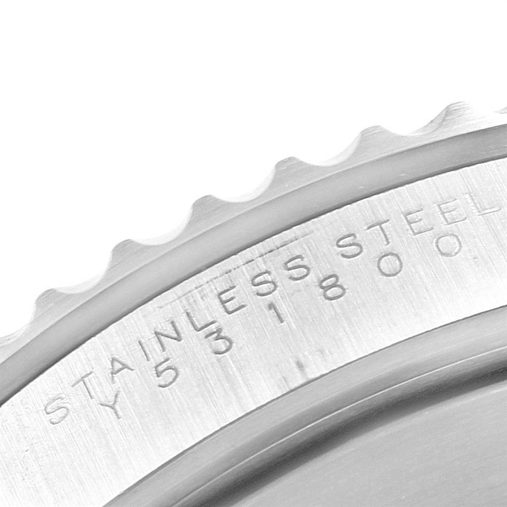 This image shows a close-up of the engraved stainless steel case back and bezel edge of a Rolex Submariner 14060 Men's Stainless Steel Black Dial 14060 Men's Stainless Steel Black Dial watch.