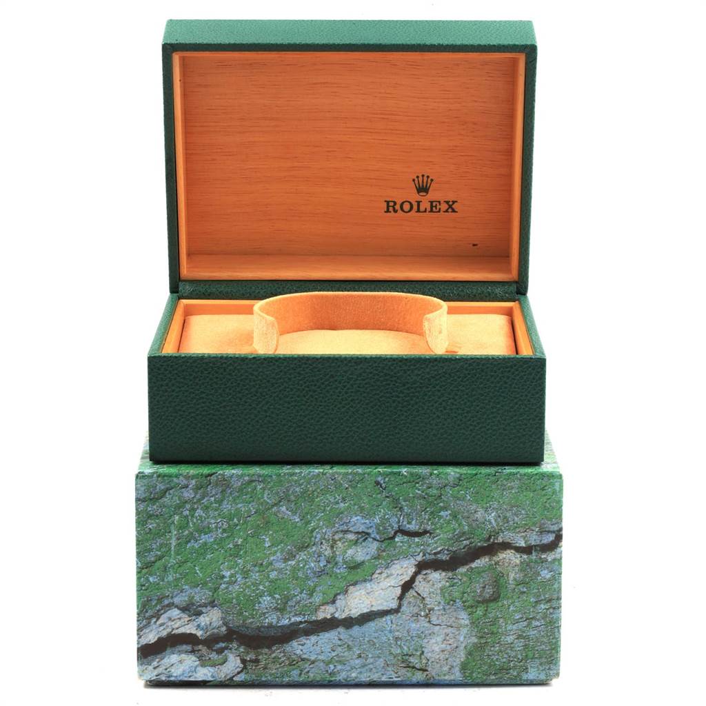 The image shows an open green Rolex watch box for the Submariner model, revealing the interior without the watch inside.
