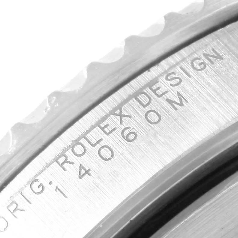 This close-up image shows the engraved bezel and part of the casing of a Rolex Submariner 14060 Men's Stainless Steel Black Dial 14060 Men's Stainless Steel Black Dial watch.