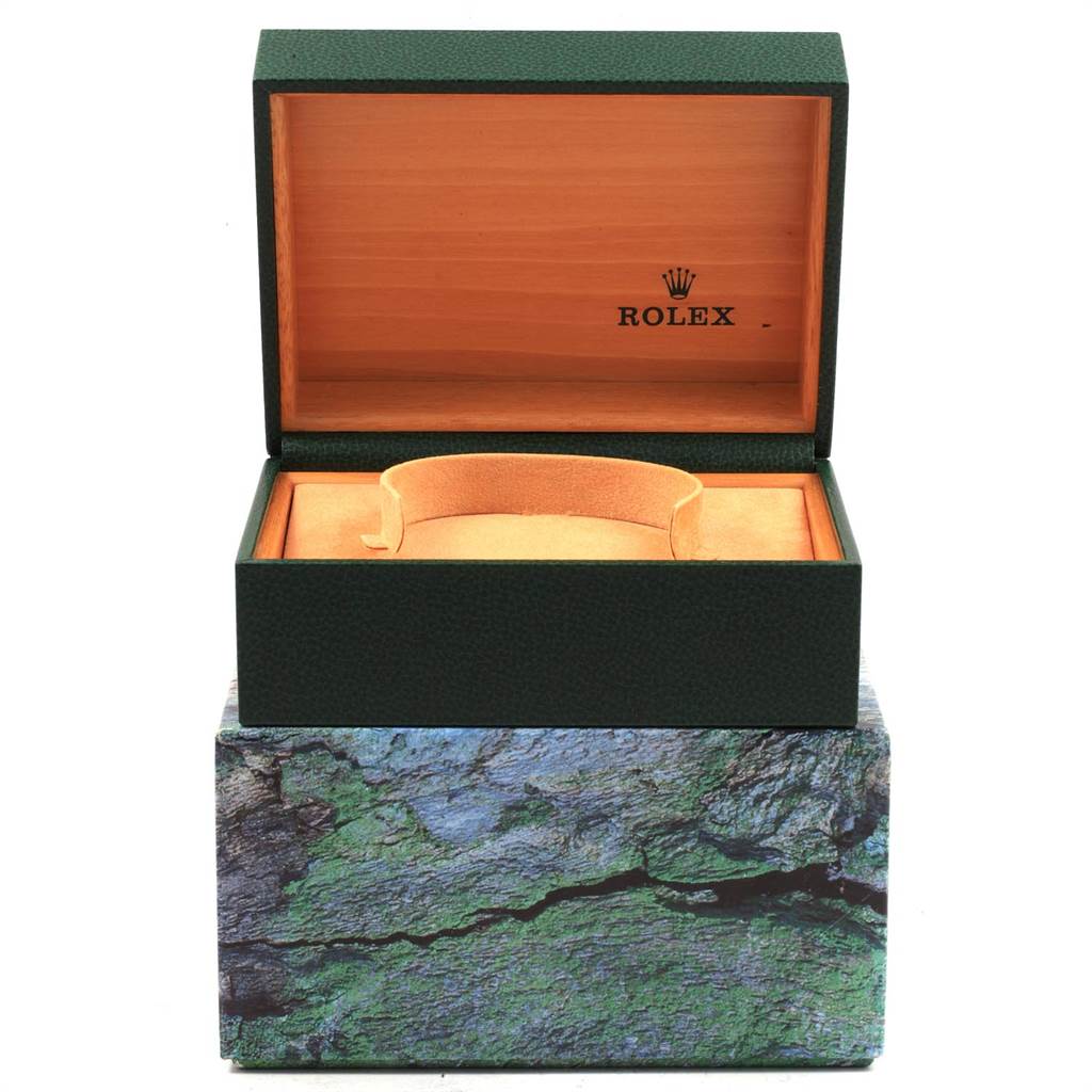 This image shows an open Rolex Submariner 16613 Men's Steel and Gold (two tone) Blue Dial 16613 Men's Steel and Gold (two tone) Blue Dial watch box with an orange interior and the Rolex logo on the lid.