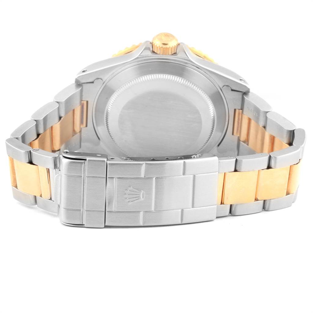 The image shows the back view of a Rolex Submariner 16613 Men's Steel and Gold (two tone) Blue Dial 16613 Men's Steel and Gold (two tone) Blue Dial watch, including the case back, crown, and metal bracelet with the clasp visible.