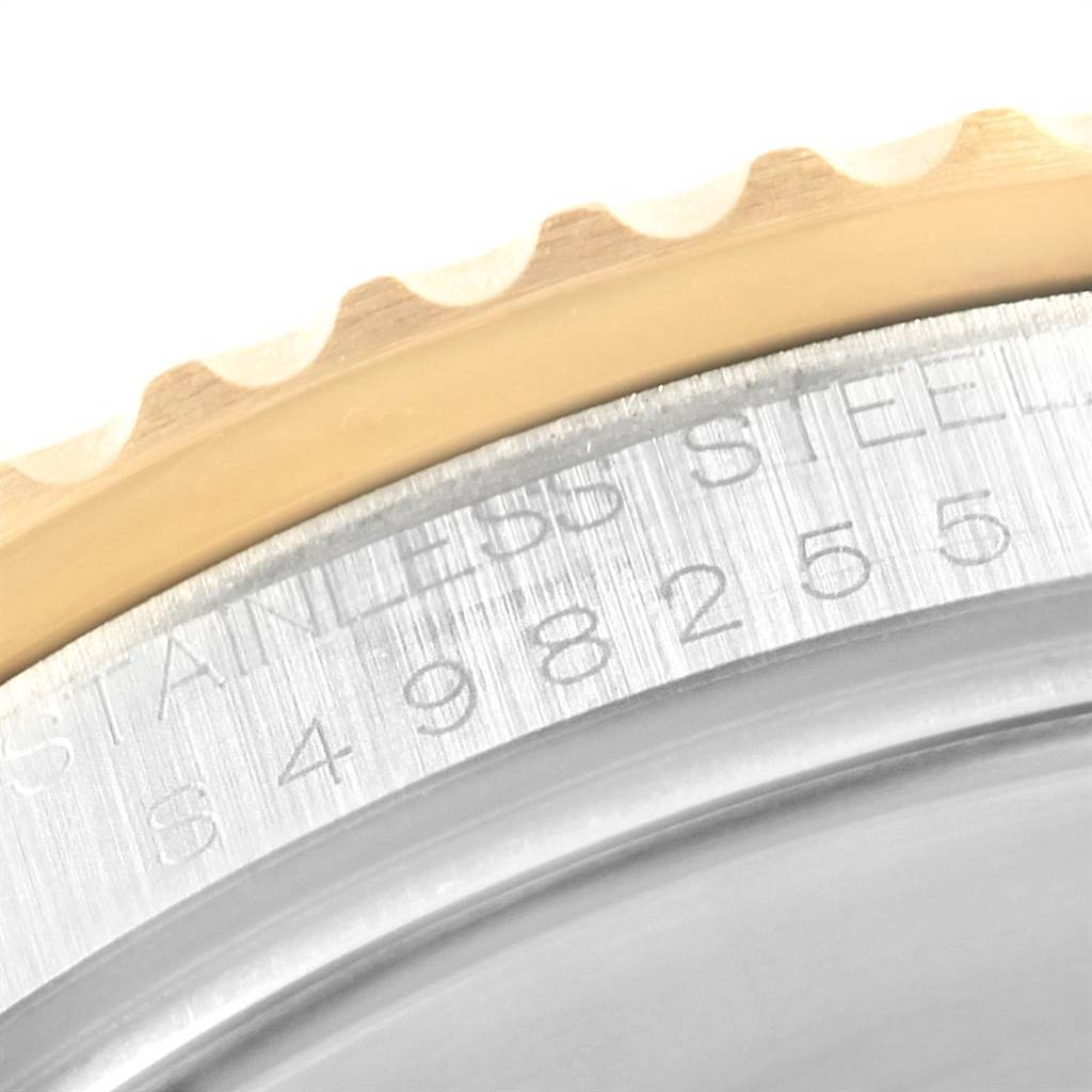 The image shows a close-up of the bezel and case back of a Rolex Submariner 16613 Men's Steel and Gold (two tone) Blue Dial 16613 Men's Steel and Gold (two tone) Blue Dial, highlighting the stainless steel engraving.