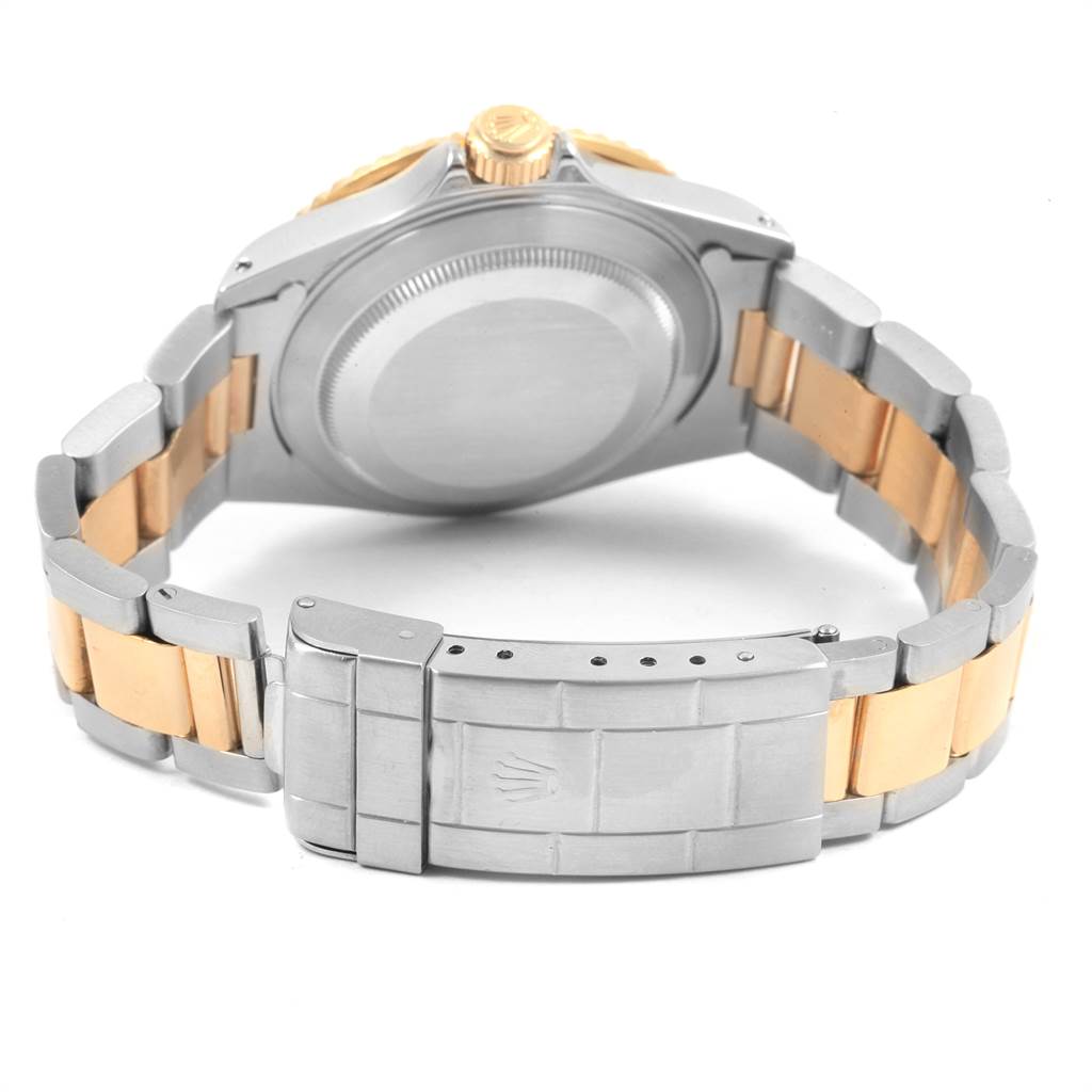 The image shows a rear angle of a Rolex Submariner 16613 Men's Steel and Gold (two tone) Blue Dial 16613 Men's Steel and Gold (two tone) Blue Dial watch, focusing on the case back and the bi-metal bracelet with clasp.