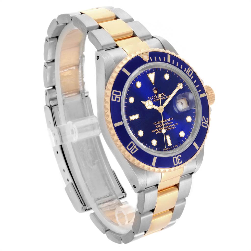 The image shows a Rolex Submariner 16613 Men's Steel and Gold (two tone) Blue Dial 16613 Men's Steel and Gold (two tone) Blue Dial watch at a slight angle, highlighting the blue dial, bezel, and two-tone metal bracelet.