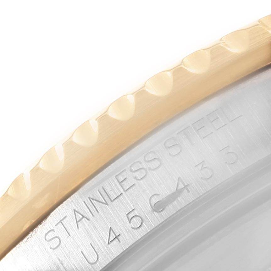 This image shows a close-up of the stainless steel and gold bezel with text on the Rolex Submariner 16613 Men's Steel and Gold (two tone) Blue Dial 16613 Men's Steel and Gold (two tone) Blue Dial watch.