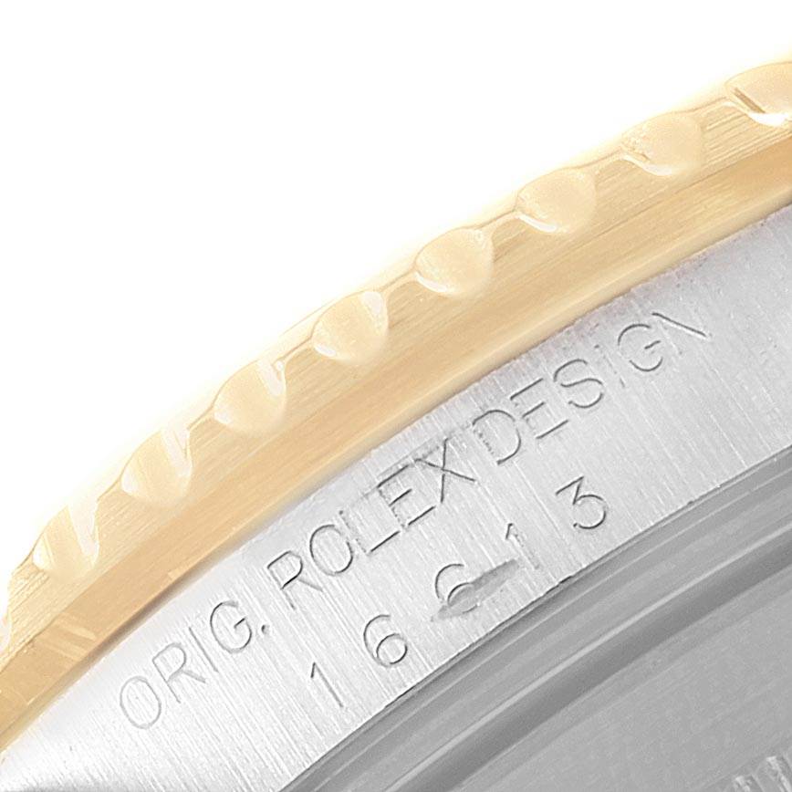 The image shows a close-up angled view of the bezel and a part of the case of a Rolex Submariner 16613 Men's Steel and Gold (two tone) Blue Dial 16613 Men's Steel and Gold (two tone) Blue Dial watch.