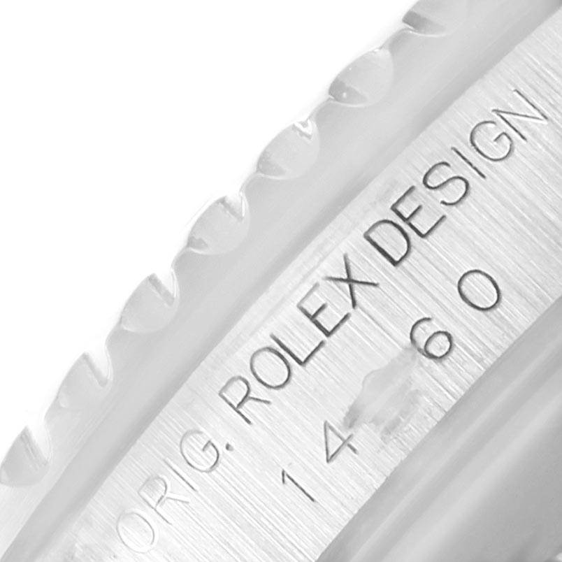 This image shows a close-up of the engraved bezel and inner rim of a Rolex Submariner 14060 Men's Stainless Steel Black Dial 14060 Men's Stainless Steel Black Dial watch.