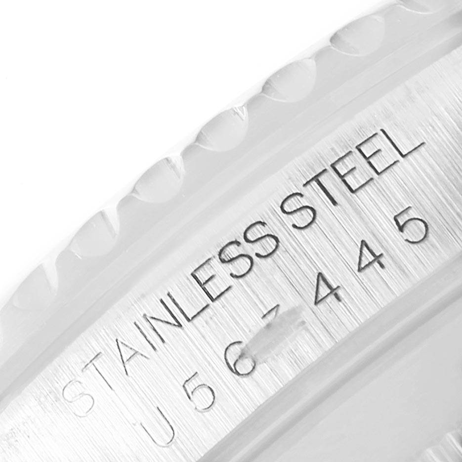 This close-up image shows the engraved stainless steel inscription and serial number on the bezel or case back of a Rolex Submariner 14060 Men's Stainless Steel Black Dial 14060 Men's Stainless Steel Black Dial.