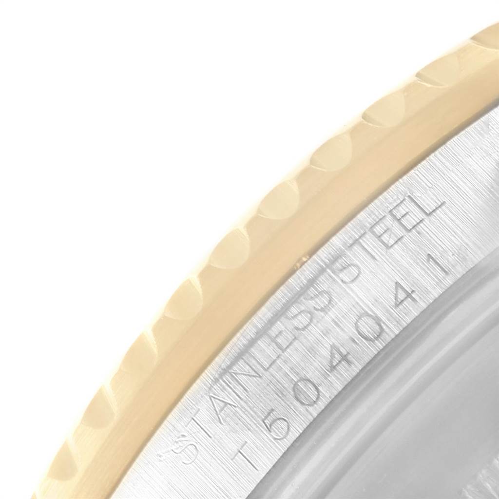 This image shows a close-up of the engraved bezel's edge and the stainless steel back case of the Rolex Submariner 16613 Men's Steel and Gold (two tone) Blue Dial 16613 Men's Steel and Gold (two tone) Blue Dial watch.