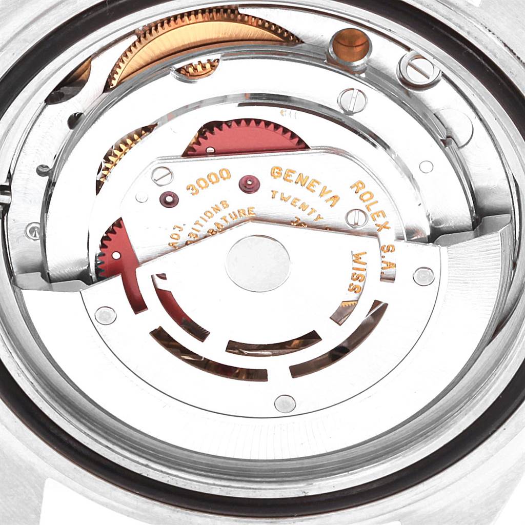 The image shows the internal mechanism of a Rolex Submariner 14060 Men's Stainless Steel Black Dial 14060 Men's Stainless Steel Black Dial watch, focusing on the movement parts and gears.