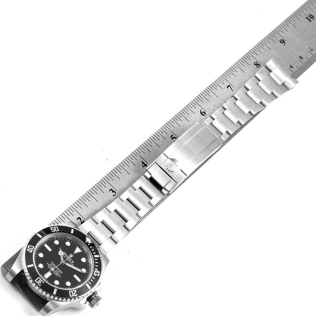 The image shows a Rolex Submariner 114060 Men
s Stainless Steel Black Dial 114060 Men
s Stainless Steel Black Dial watch laid flat with a ruler measuring the metal bracelet and clasp.