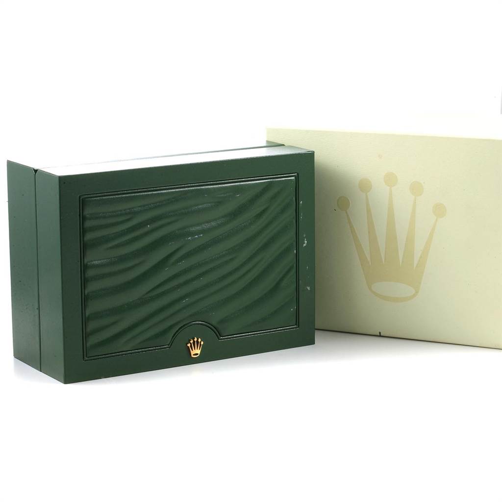 The image shows the closed green box and outer case for a Rolex Submariner 114060 Men
s Stainless Steel Black Dial 114060 Men
s Stainless Steel Black Dial watch from a slightly angled front view.