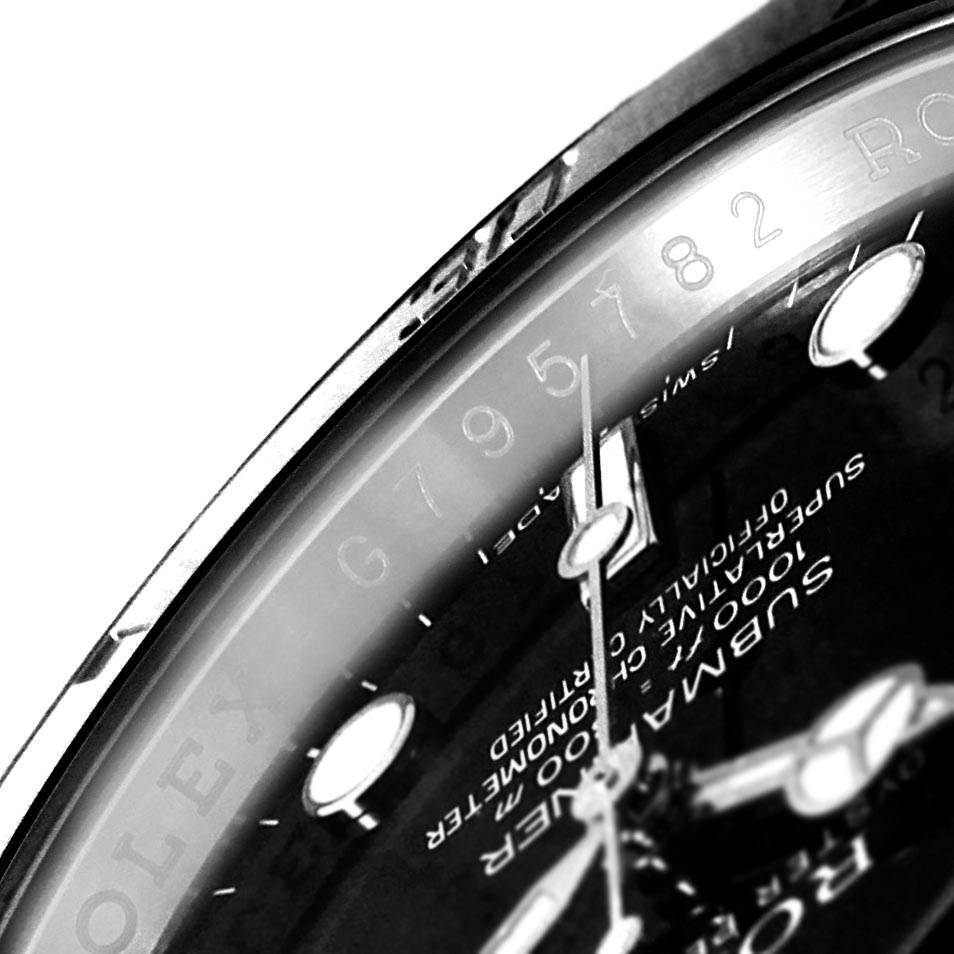 This close-up image of the Rolex Submariner 114060 Men
s Stainless Steel Black Dial 114060 Men
s Stainless Steel Black Dial showcases part of the dial and bezel at an angle.